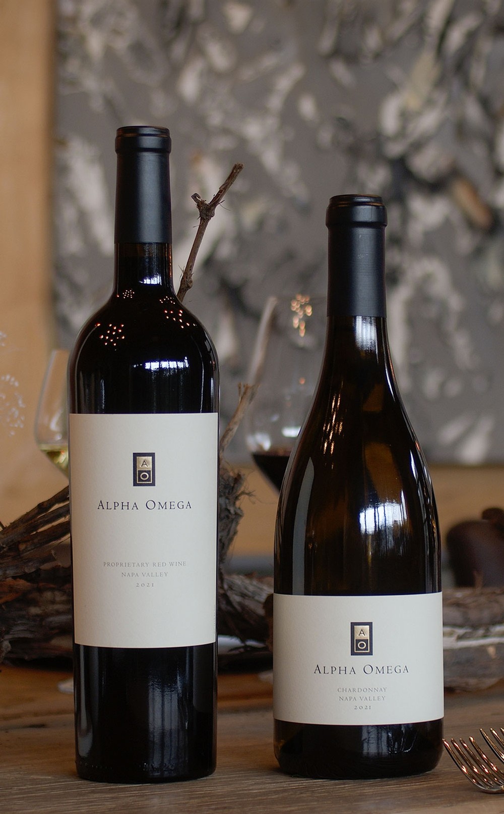 Two bottles of Alpha Omega wine on table